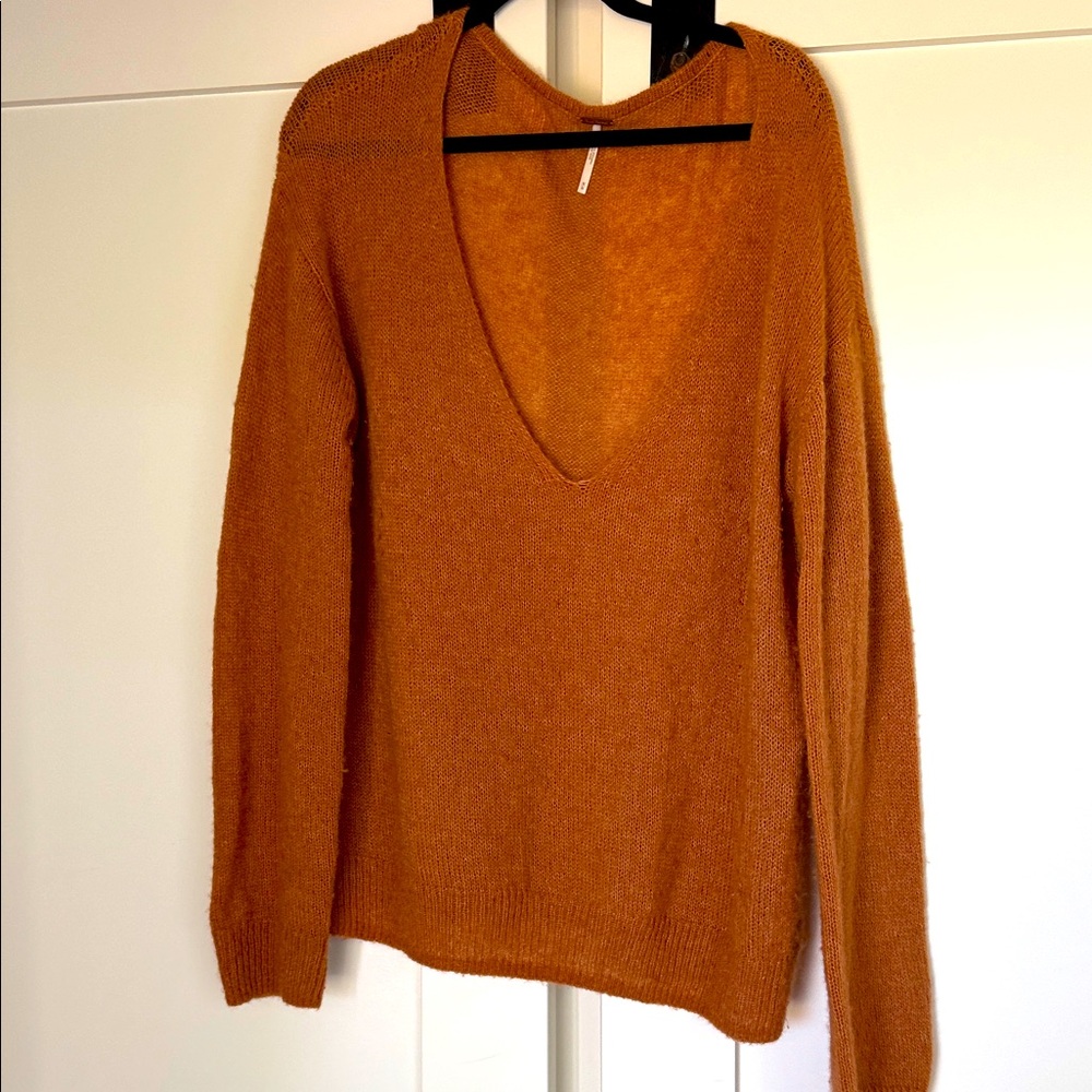 Free People oversize V-Neck Sweater in Warm Orange.